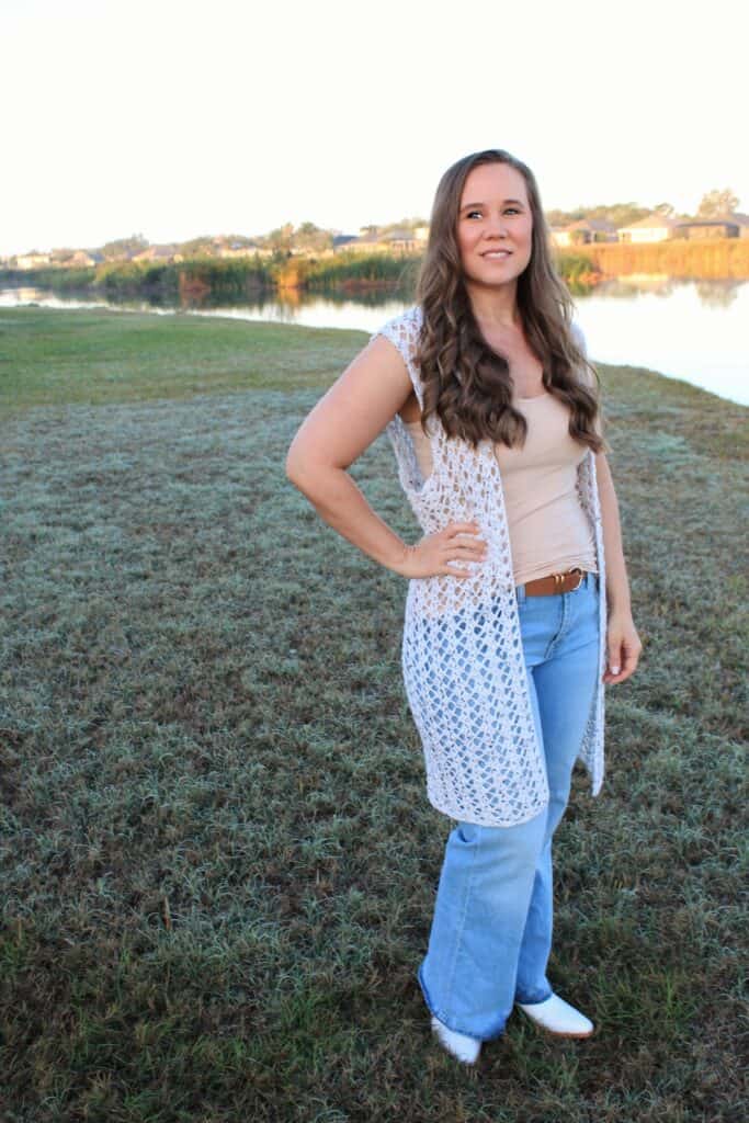 Woman wearing a summer crochet vest, called the Summer Stroll Vest. This crochet pattern features instructions for women's sizes XS-5X.