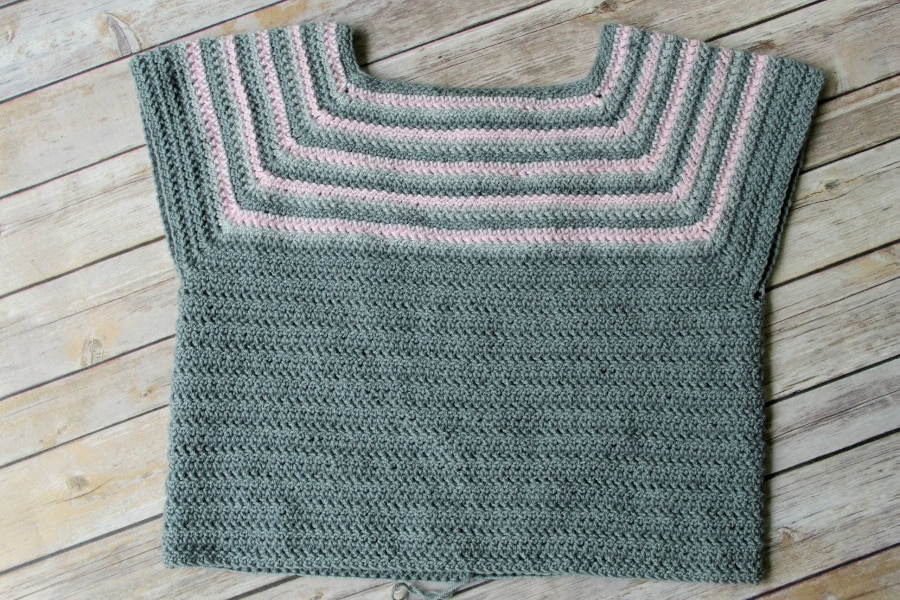 A flat lay of a raglan crochet sweater pattern in progress. 