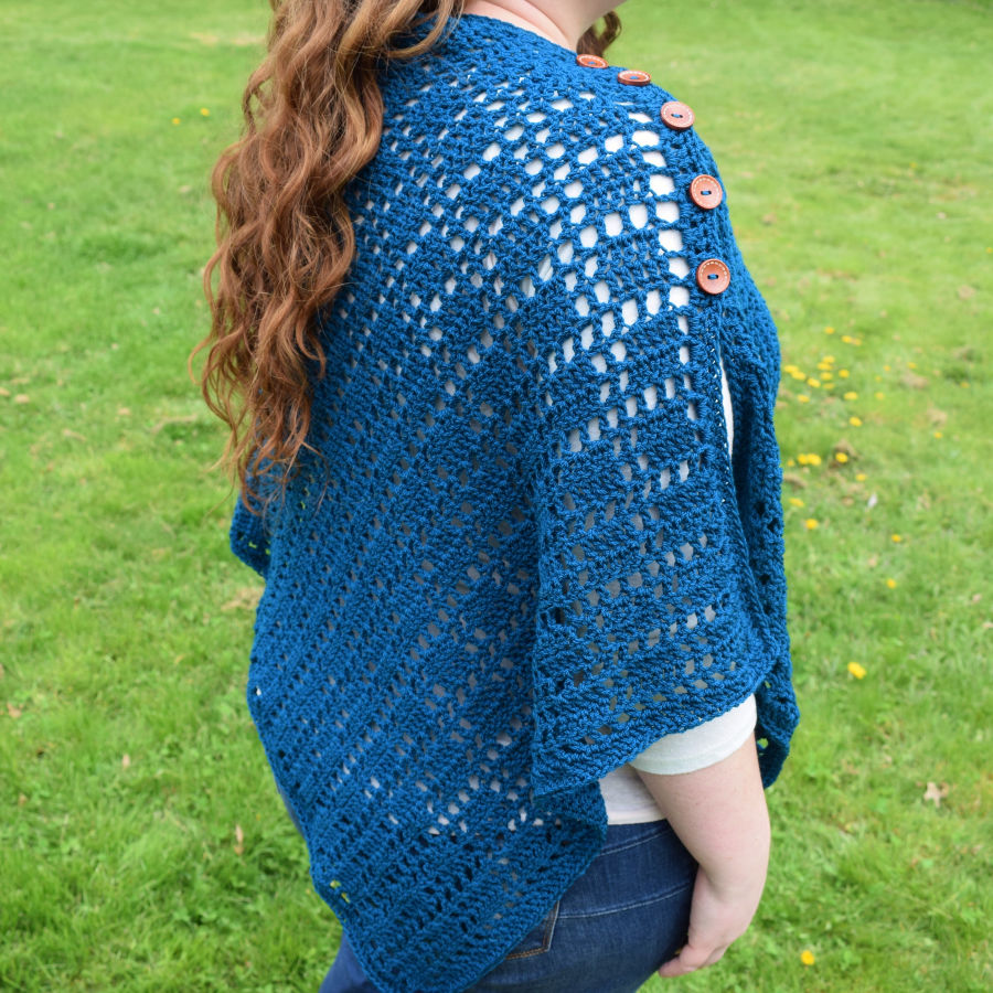 Poncho style wrap with buttons down the shoulder. 