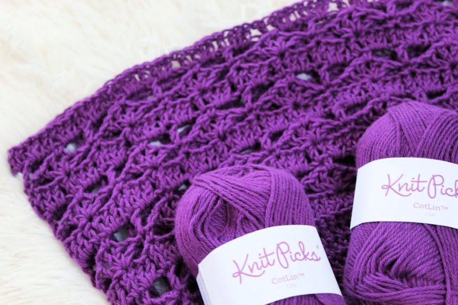 Knit Picks Cotlin Yarn  in the color Lilac laid on top of the Calla Lily Market Bag to display the gorgeous color of the yarn. 