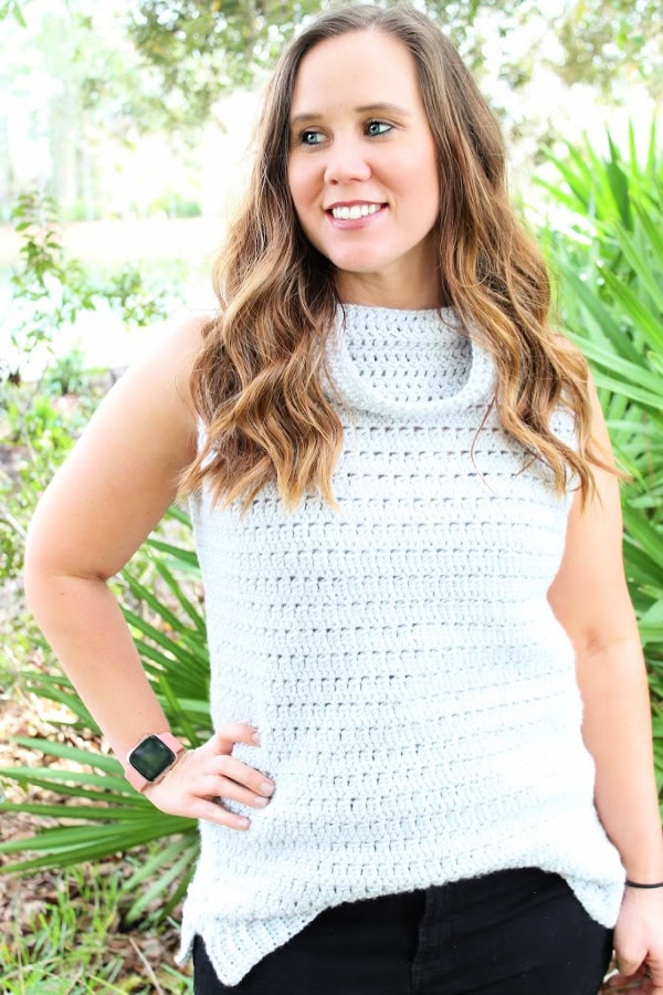 Woman wearing gray sleeveless sweater called the Rory Sleeveless Sweater.  