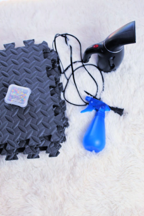 Blocking supplies including foam mats, pins, a handheld steamer, and a spray bottle. 