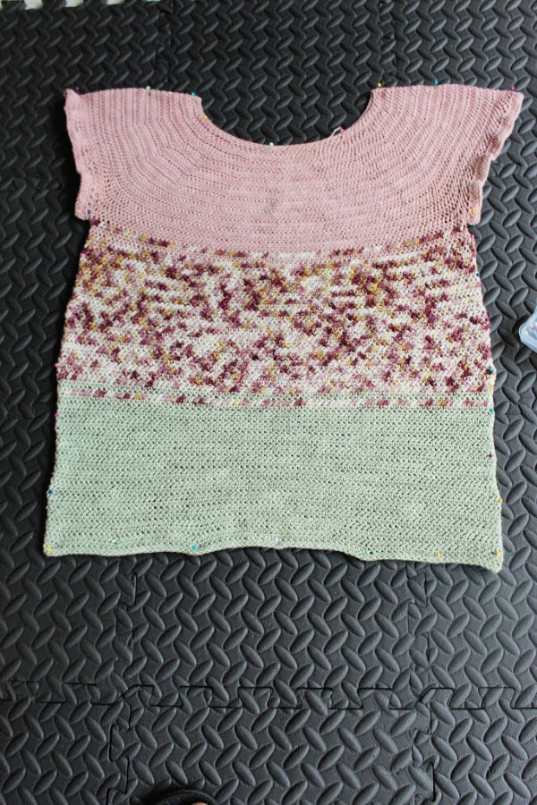 Photo of crocheted top pinned to foam blocking mats and ready to be blocked. 