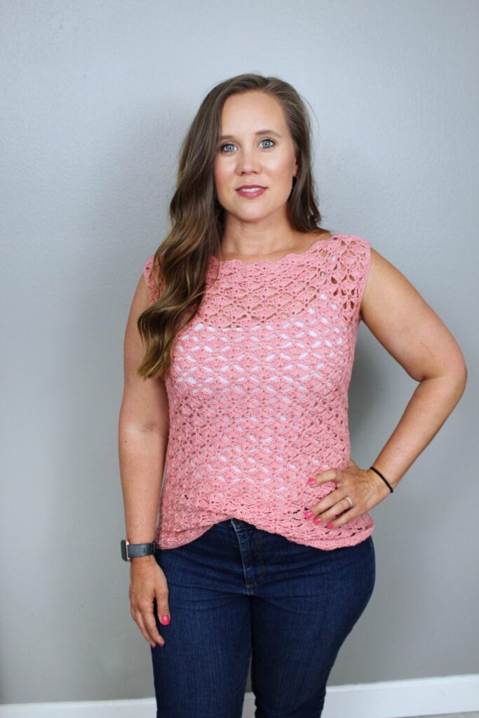 Woman wearing sleeveless crochet top called the Sadie Shell. 