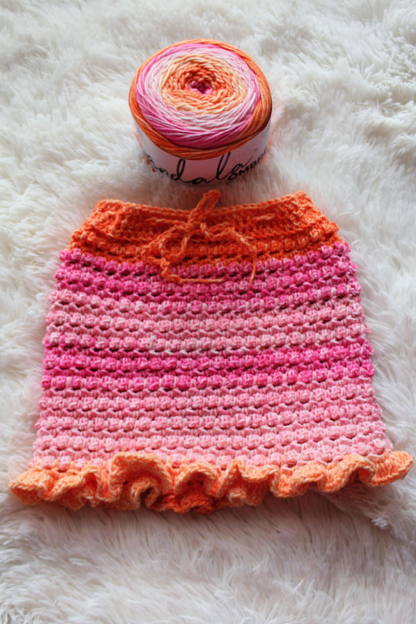 The crocheted Little Textures Baby Skirt with Lion Brand Yarn Mandala Ombre yarn. 