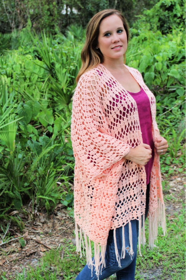 Woman wearing a summer crochet cardigan called the Sarasota Cardi. 