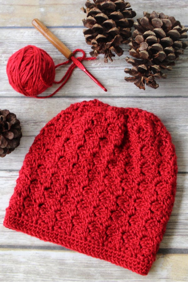 Flat lay of red crochet hat, called the Dallas Hat. 