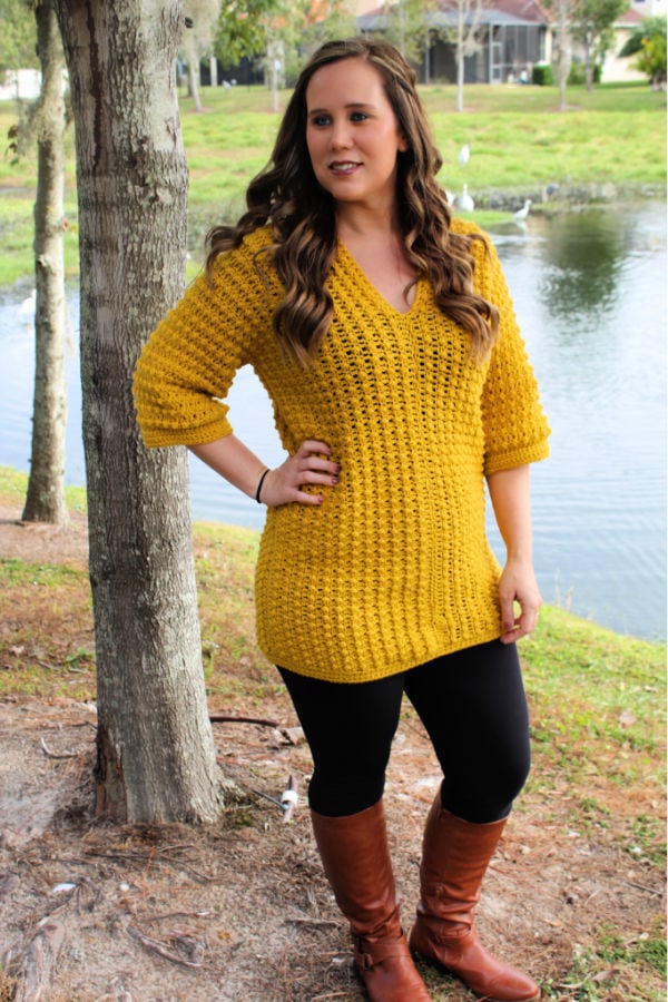 Woman wearing a yellow crochet tunic called the Tuscan Sun Tunic. 