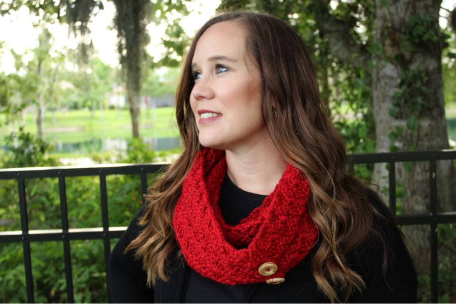 Woman wearing red crochet infinity scarf called the Dallas Scarf.