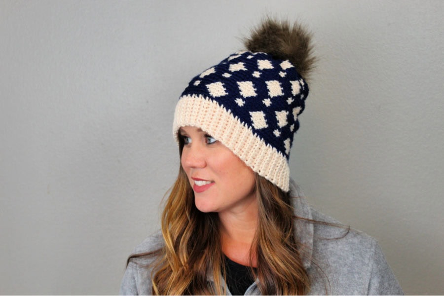 Woman wearing a fair isle crochet blue and cream hat, called the Gatlinburg Hat. 