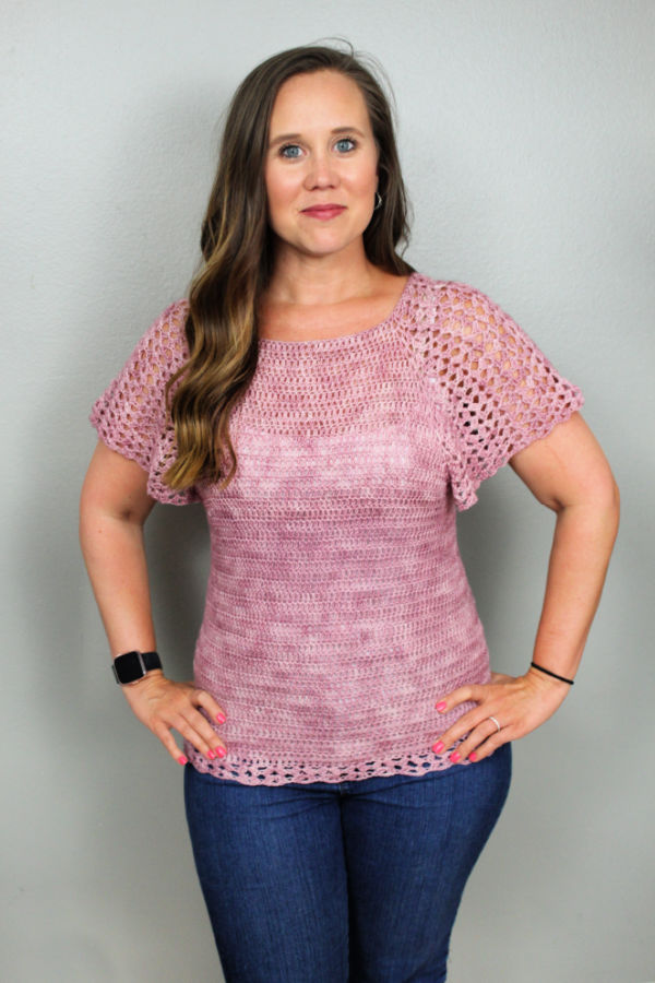 Woman wearing a pink summer crochet top called the Rosie Tee. 