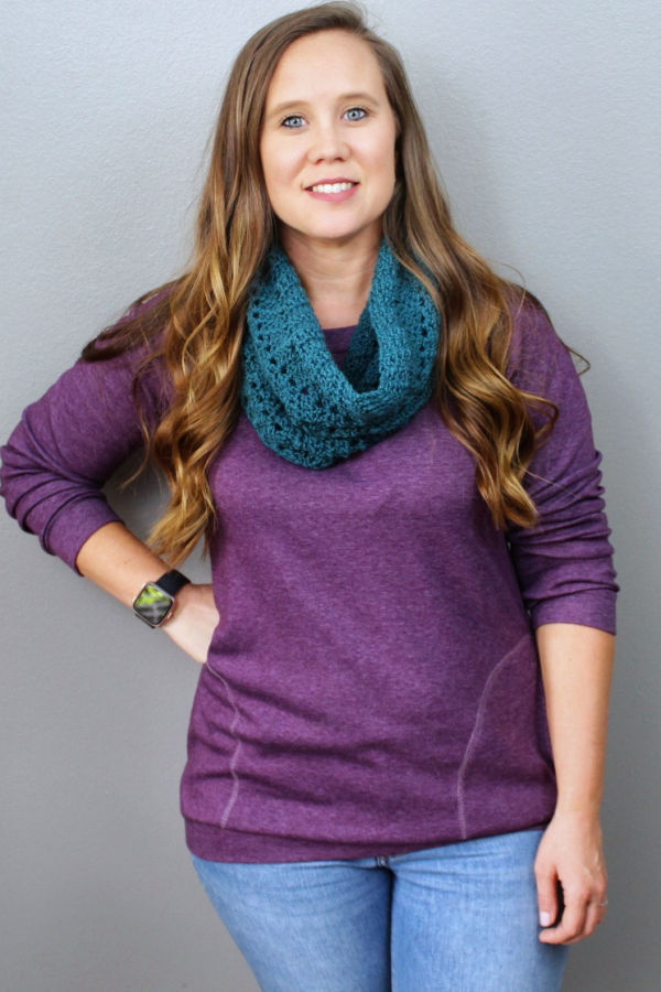 Woman wearing a green crochet cowl, called the Chevy Cowl. 