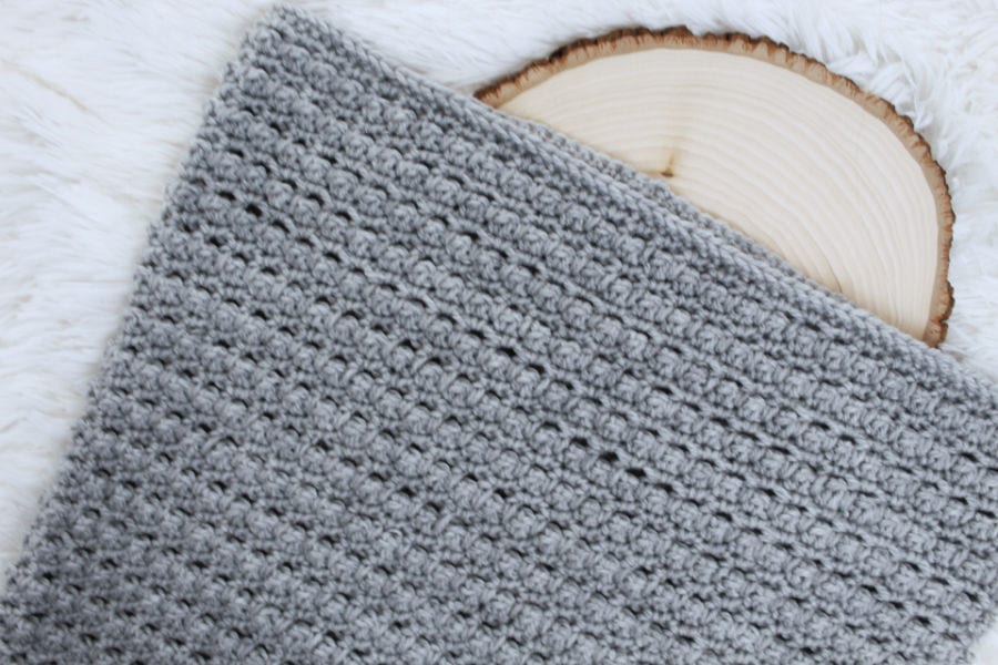 Flat lay photo of a gray hooded cowl, called the Little Textures Hooded Cowl. 