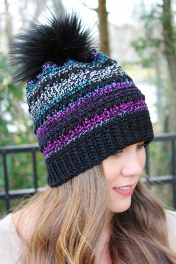 Woman wearing a crochet hat called the CC Hat. 