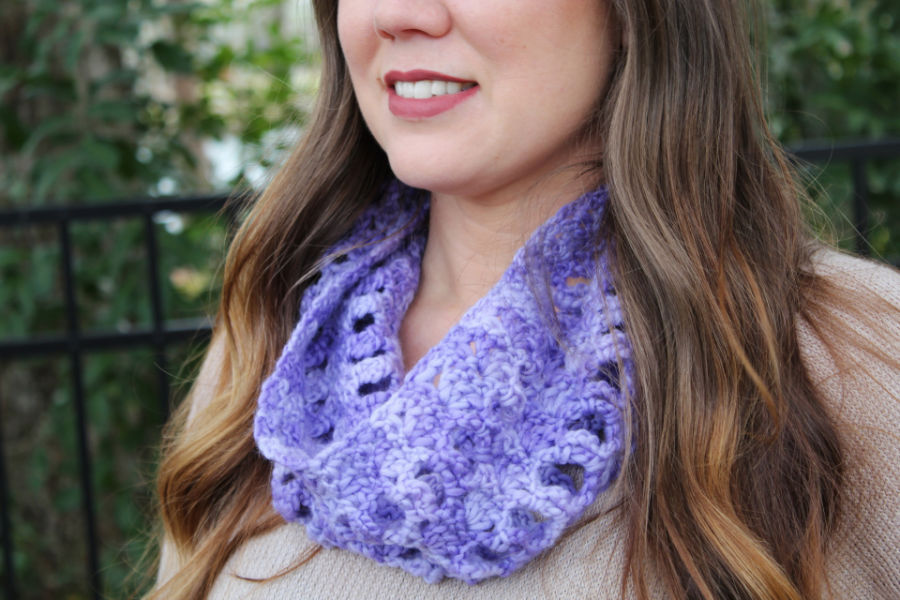 Close up of woman wearing a light purple crochet cowl, called the Kellie Cowl. 