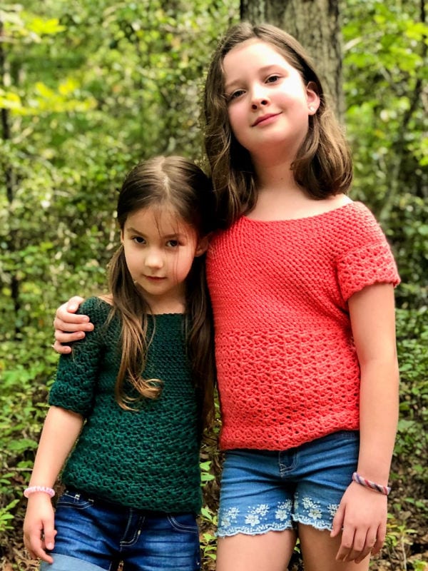 Two girls wearing different variations of a crochet top, called the Primrose Blouse.