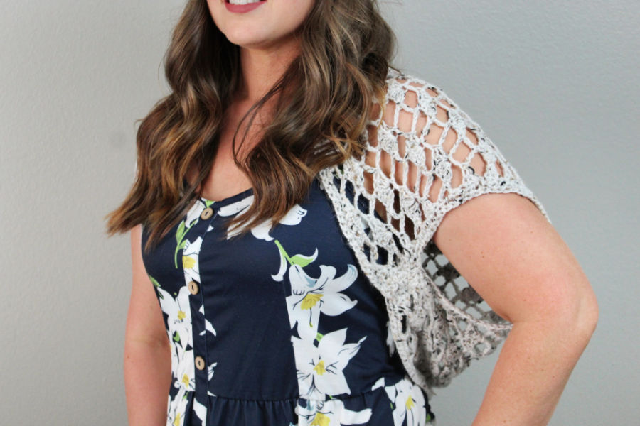 Close up of woman wearing a crochet shrug called the Nova Shrug. 