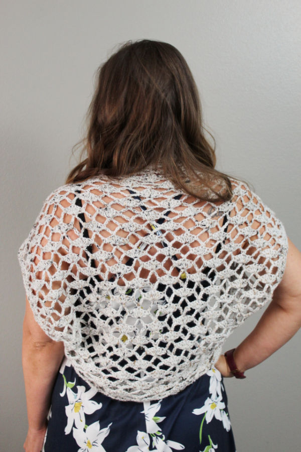 Back view of woman wearing a crochet shrug called the Nova Shrug. 