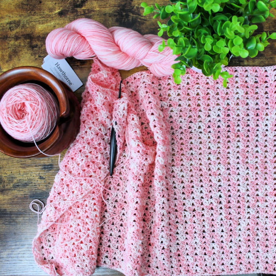 Flatlay yarn photo of the pink yarn used to make the summer crochet cardigan called the Jayda Cardigan. 