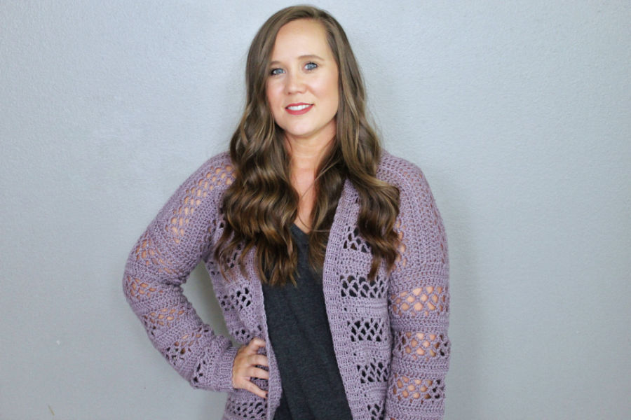 Woman wearing a light purple crochet cardigan called the Magnolia Cardigan. 