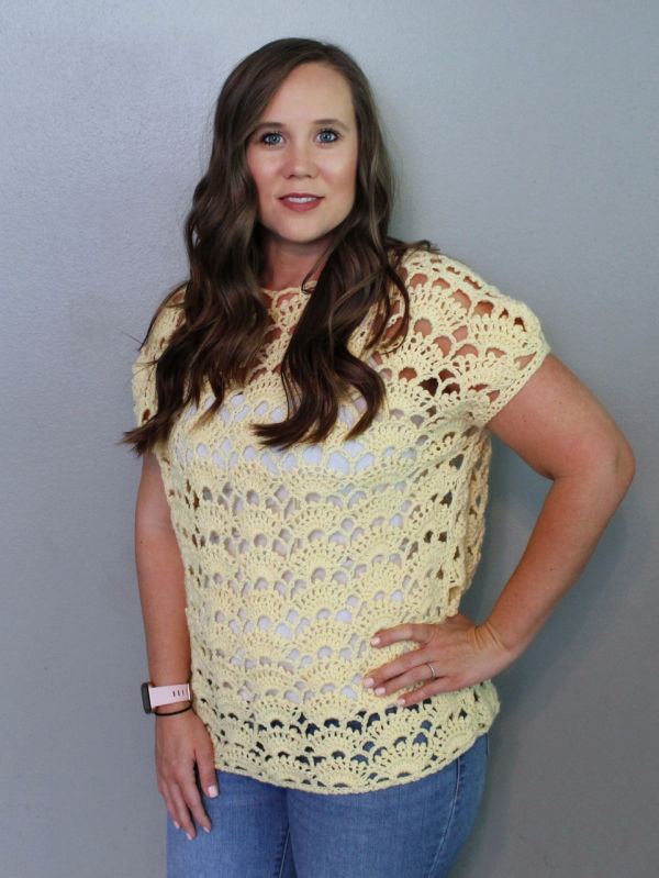 Woman wearing a yellow crochet top, called the Santa Anna Tee. 