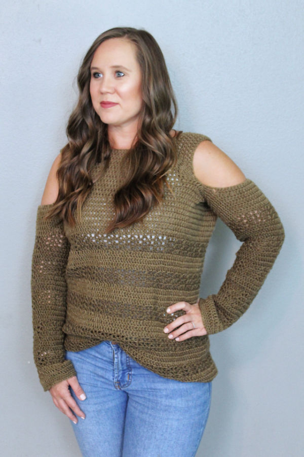 Woman wearing a crochet sweater called the Calgary Cold Shoulder Sweater. 