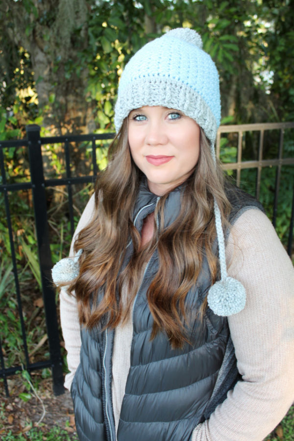 Woman Wearing a blue and gray crochet hat, called the Kristen Slouch.