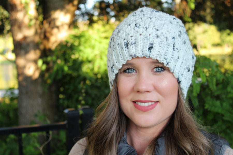 Woman wearing a crochet slouch hat, called the Savannah Slouch. 