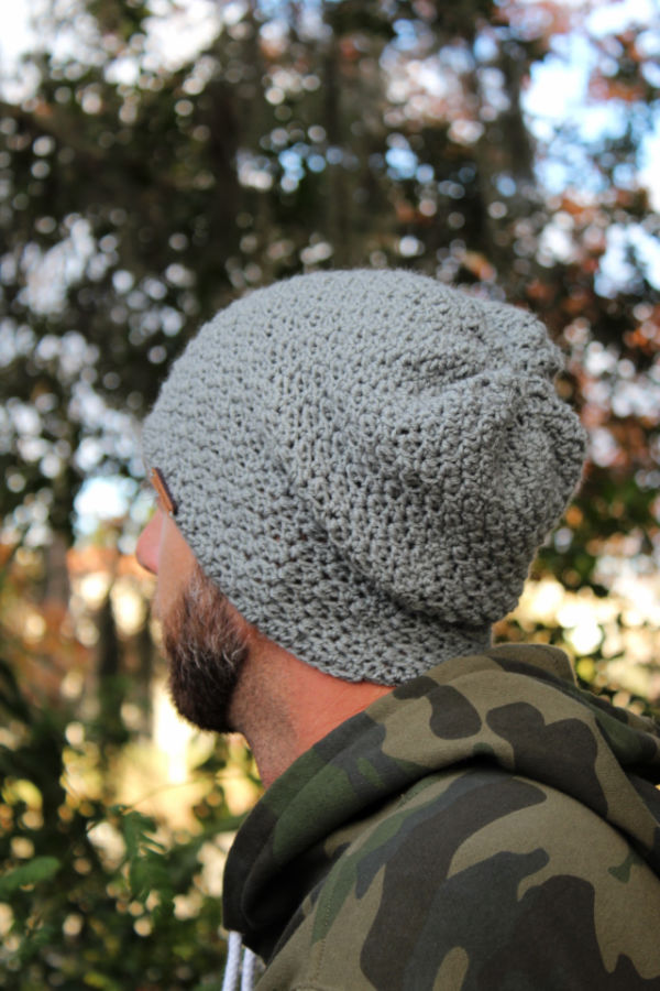 Man wearing a gray crochet slouch hat, called the Boston Slouch. 