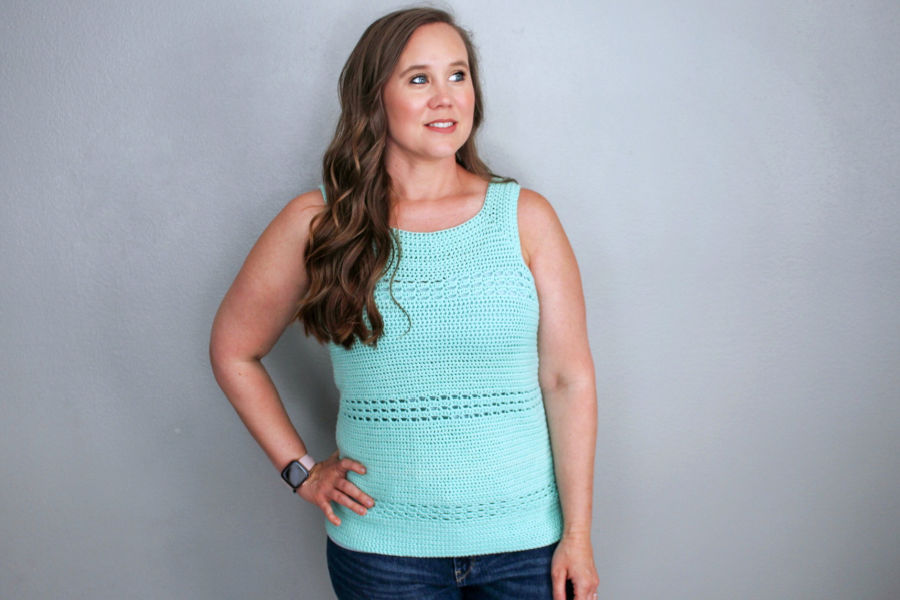 Woman wearing a mint green crochet tank top, called the Blushing Eyelets Tank. 