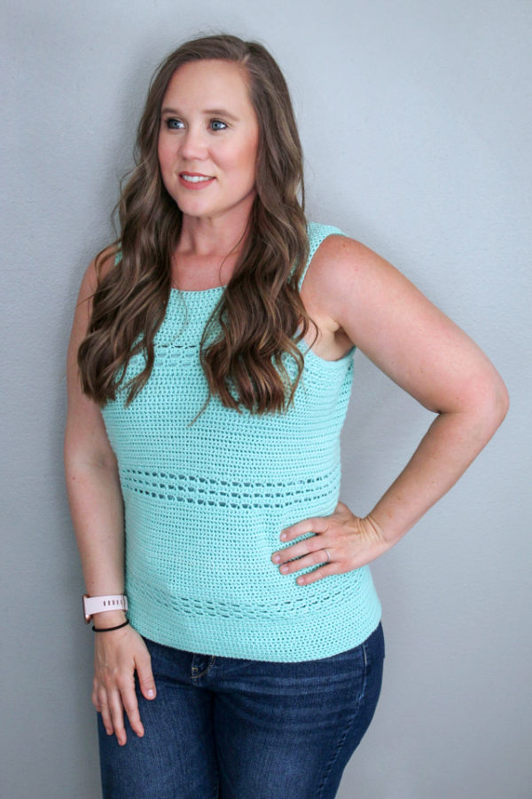 Woman wearing a mint green crochet tank top, called the Blushing Eyelets Tank. 