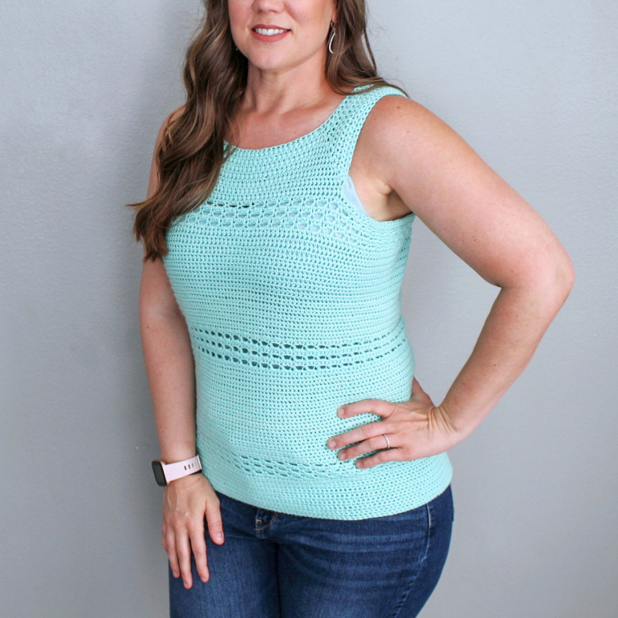 Close up photo of a mint green crochet tank top, called the Blushing Eyelets Tank. 