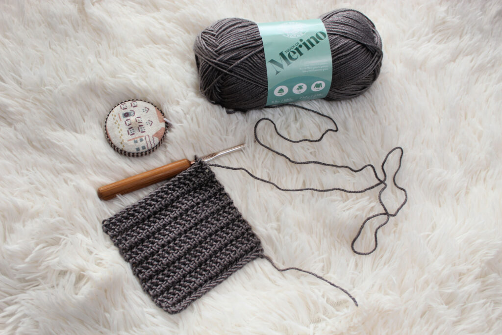 Yarn, crochet hook, measuring tape, and gauge swatch. 