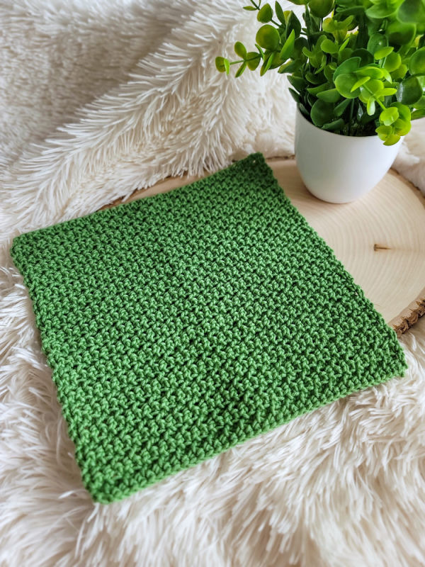 Green crochet washcloth, called the Bramley Washcloth.
