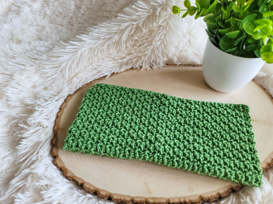 Green crochet washcloth, called the Bramley Washcloth. 