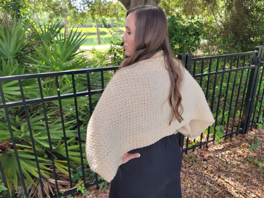 Back of the Camellia Shardi, a crochet shawl with sleeves. 