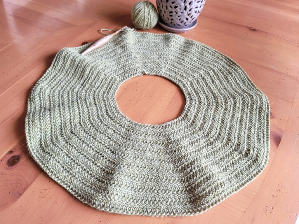 Flat lay image of the yoke of a crochet sweater dress.