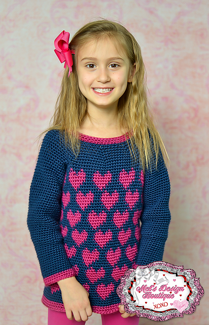 Child wearing a crochet heart sweater called the Paris Sweater. 