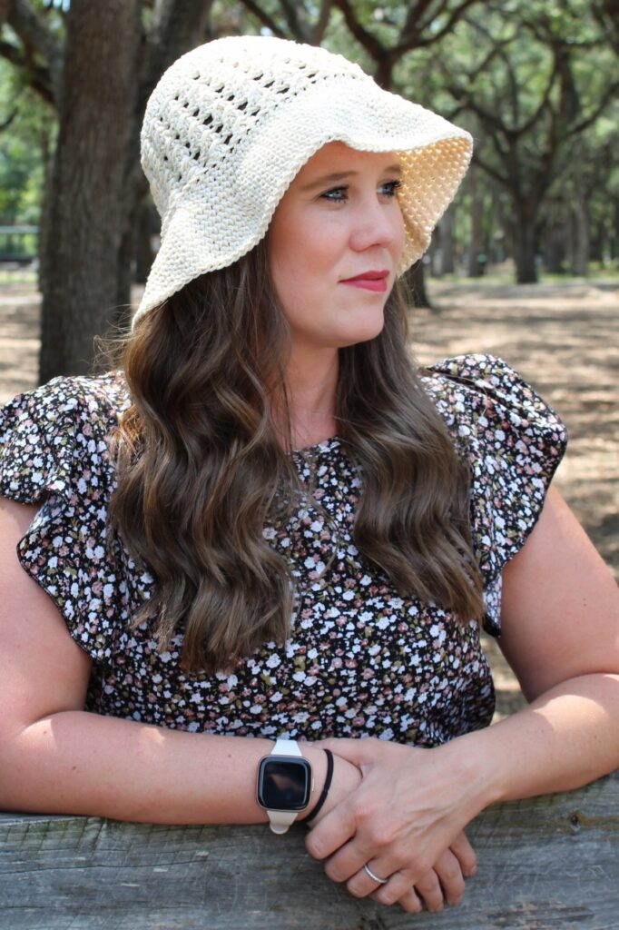 Woman wearing a crochet sun hat. 
