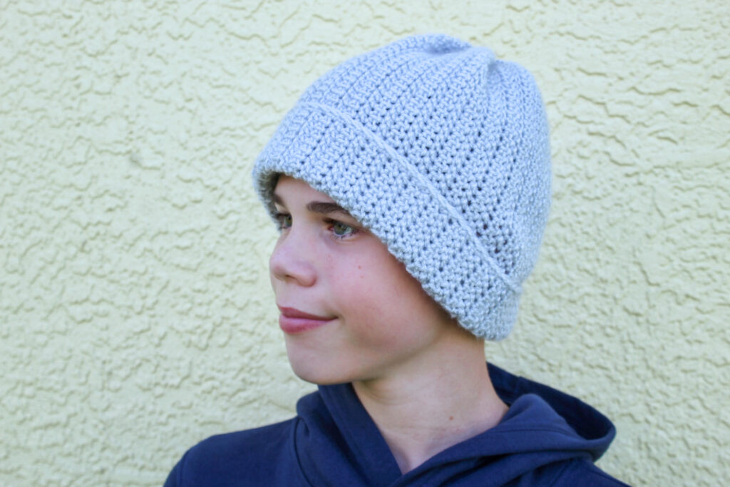 Boy wearing a gray crochet beanie, called Pop's Beanie.