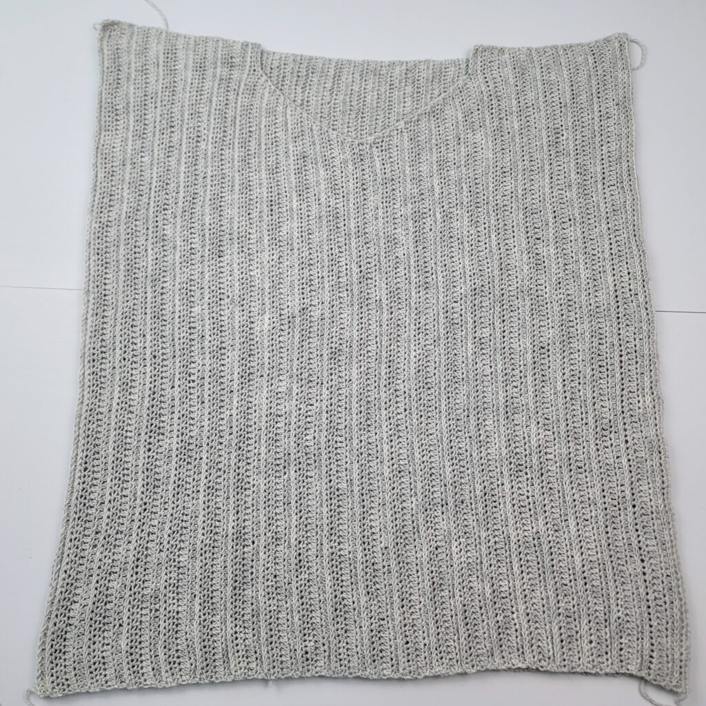 Flatlay of crochet sweater.
