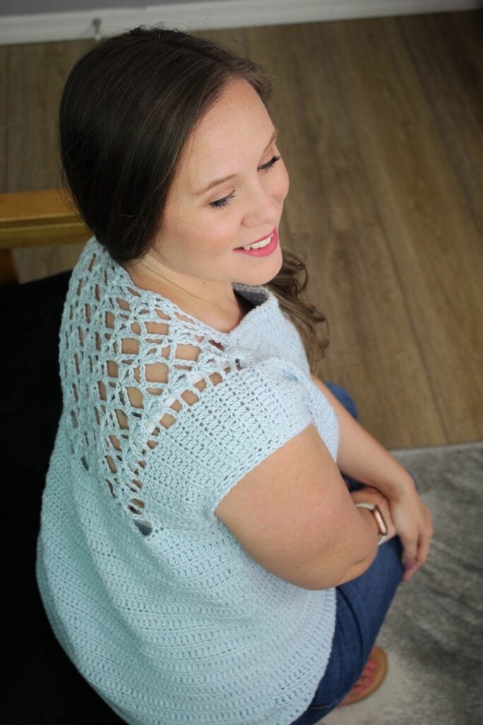 Woman wearing a crochet top pattern, called the Tea Time Tee.
