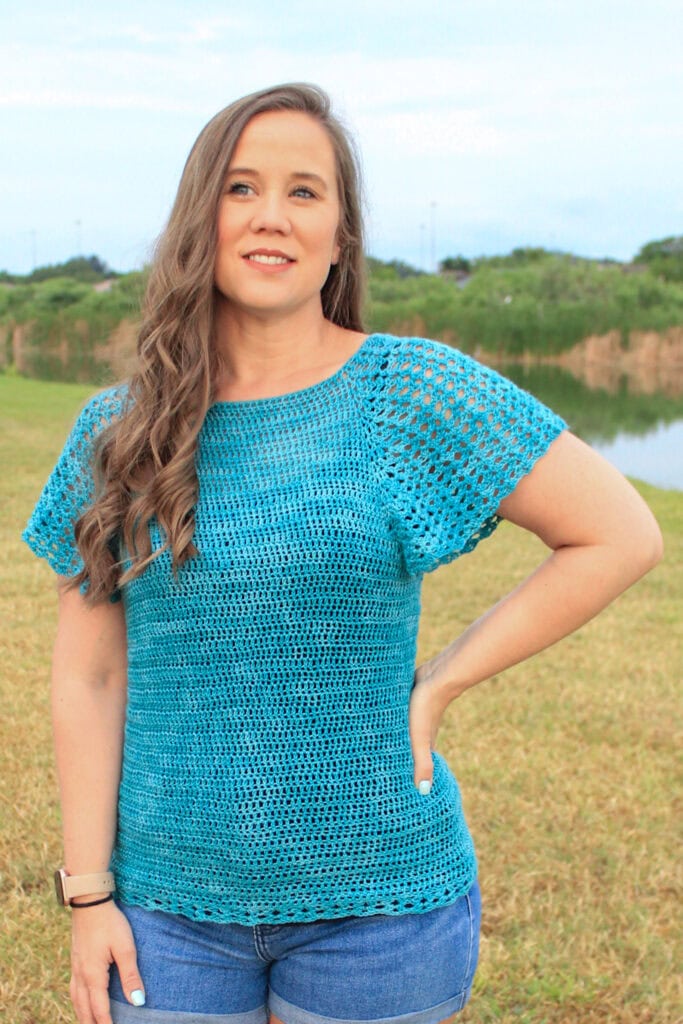 Woman wearing a summer crochet top.