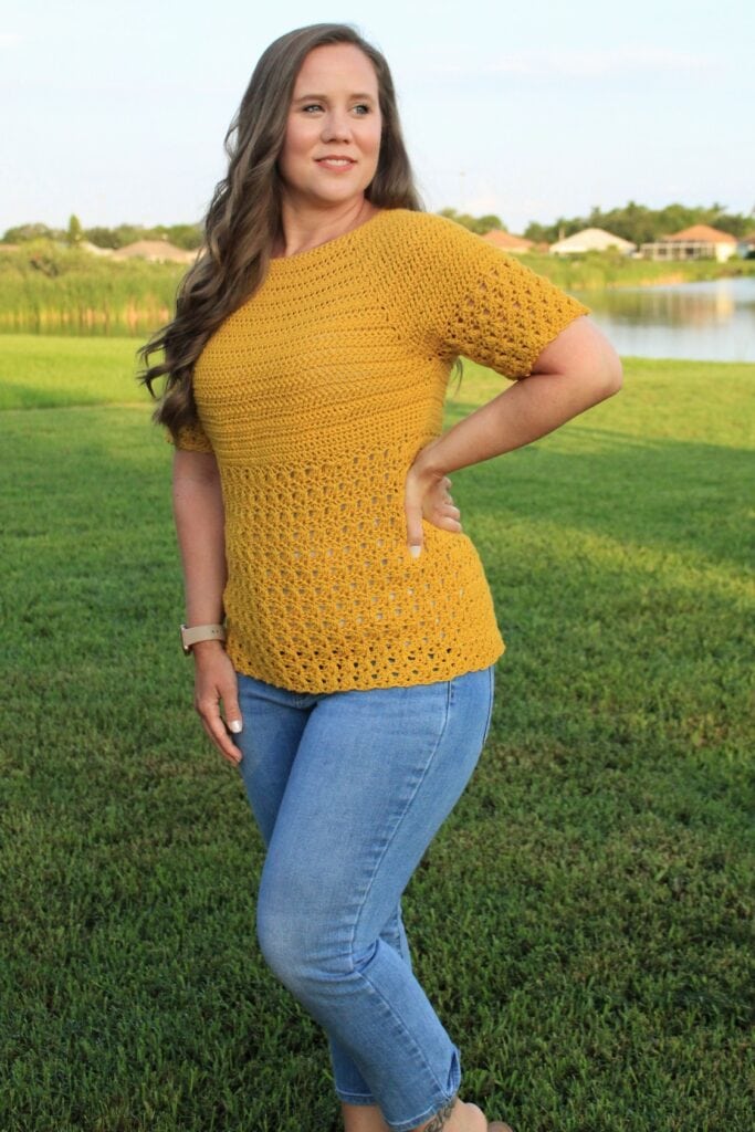 Woman wearing a yellow crochet top, called the Primrose Blouse