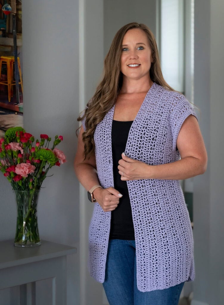 Woman wearing a crochet vest called the First Cuppa Vest.